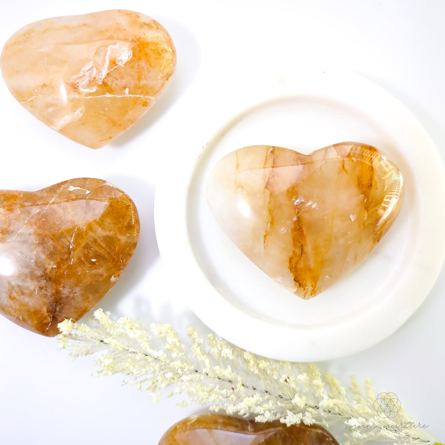 golden healer crystal hearts laid out with a flower and marble circle backddrop. For sale at Inner Nurture - online crystal store australia