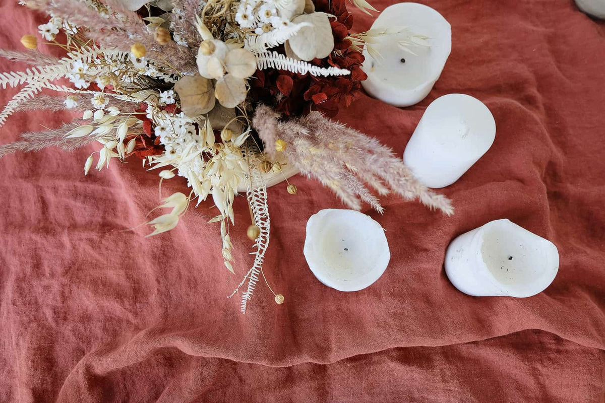 halloween energy - samhain golden healer towers in nature surrounded by green leaves and moss and branches.