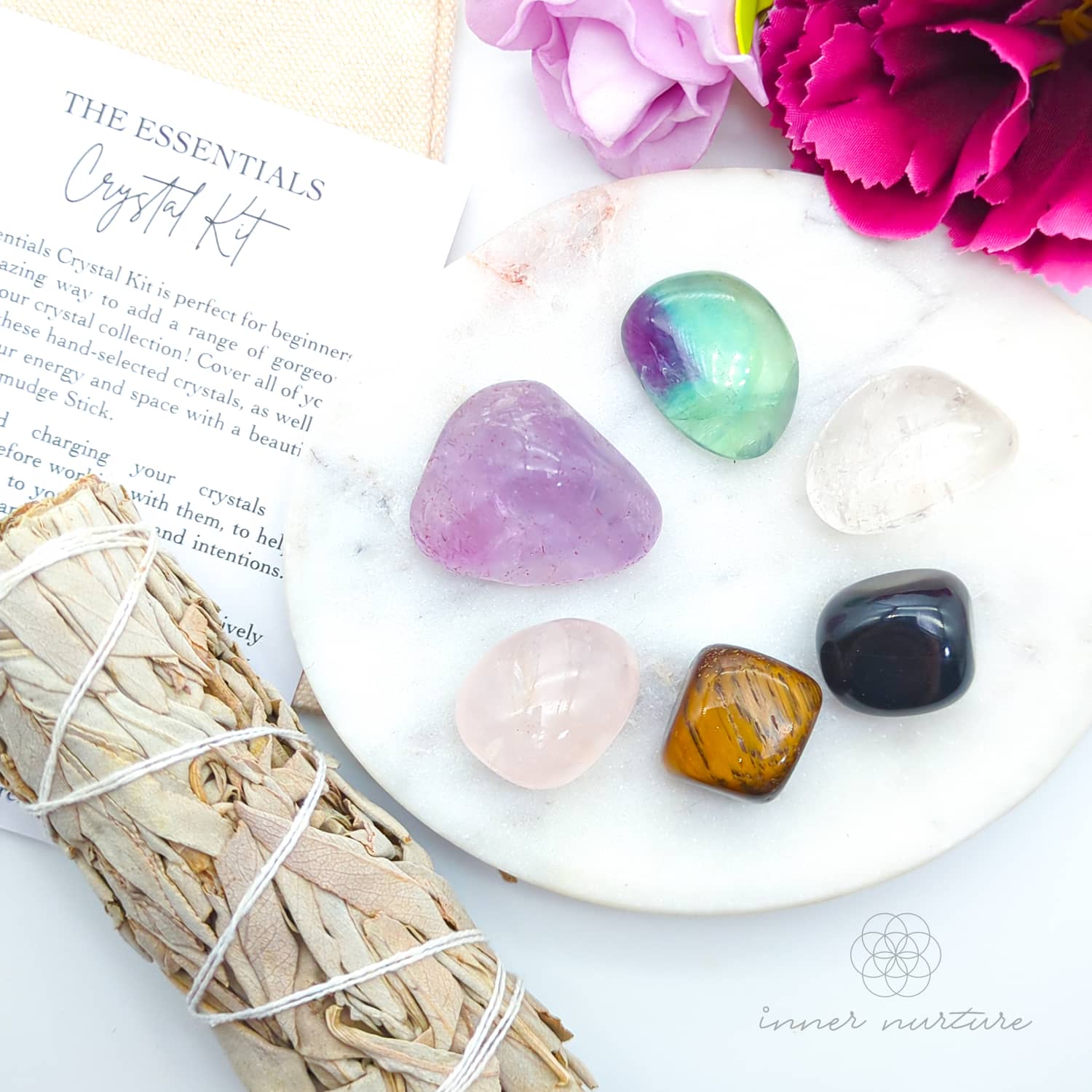 Crystal kit with crystals, smudge stick, and flowers on a white surface.  Essentials Crystal Kit, available on line in Australia at Inner Nurture