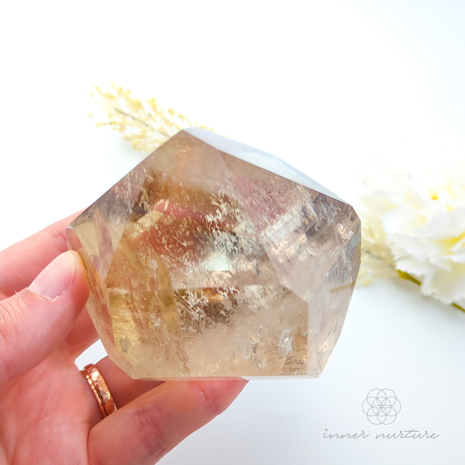 Citrine crystal on a white background with dried flowers. Citrine (Natural) Free Form #2 for Abundance & Manifestation | Crystals Australia Inner Nurture
