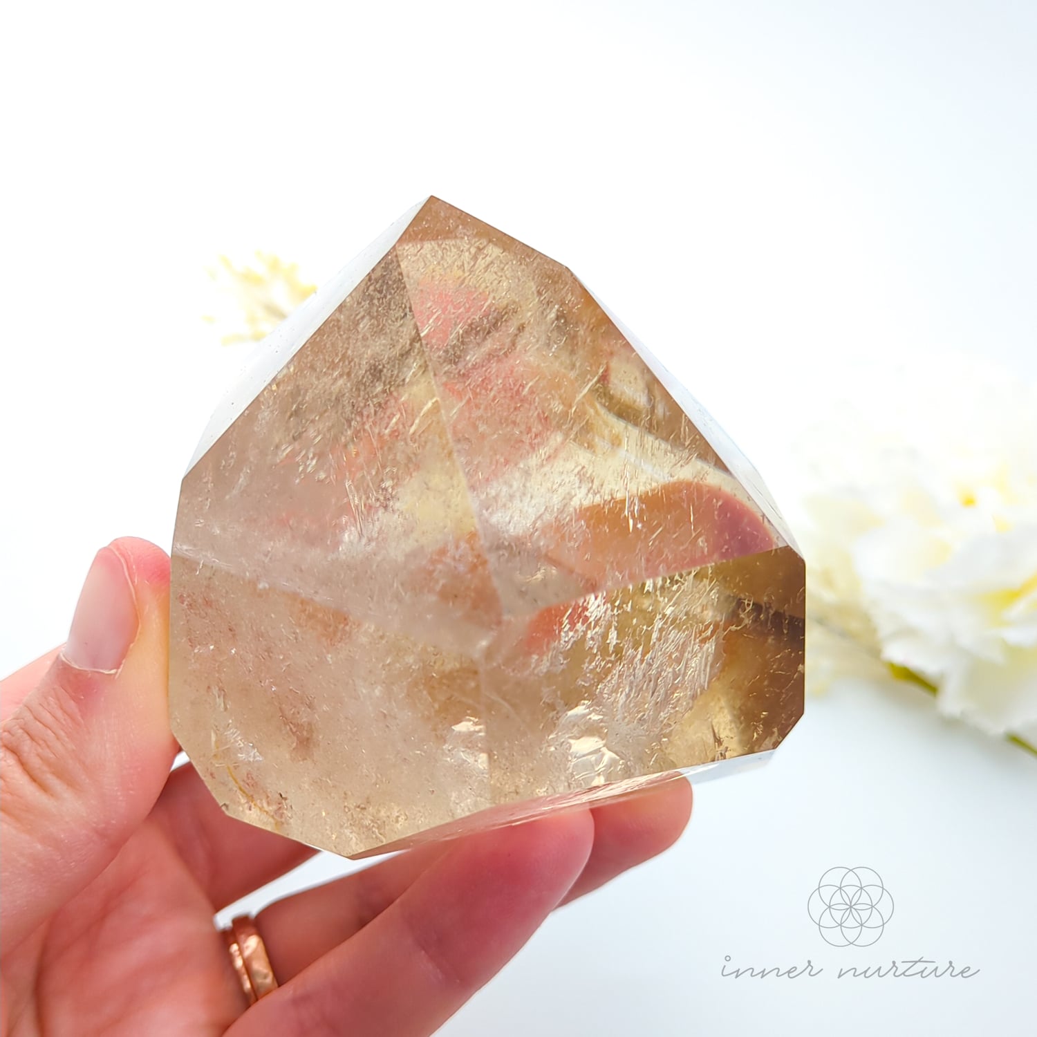 Citrine crystal on a white background with dried flowers. Citrine (Natural) Free Form #2 for Abundance & Manifestation | Crystals Australia Inner Nurture