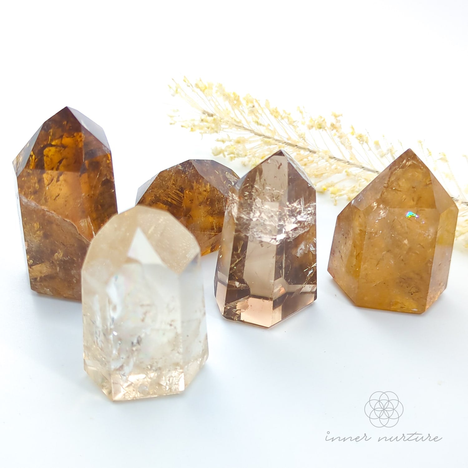 Set of crystal points on a white background with 'inner nurture' branding. Citrine (Natural) Tower for Abundance & Manifestation | Crystals Australia